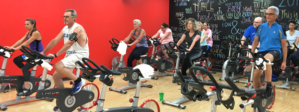 Community members participating in spinning exercise class