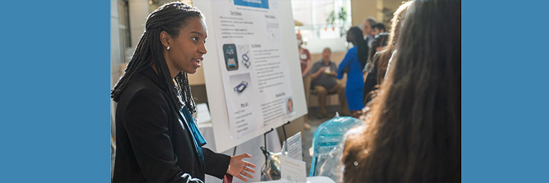 Students talk at a research event.