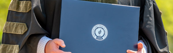 Graduate holding diploma