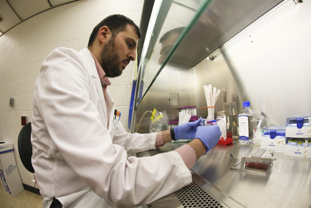 Nazar Hussain working to prepare cells