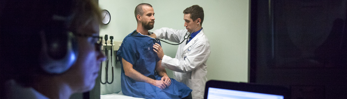 Student working with standardized patient during assessment