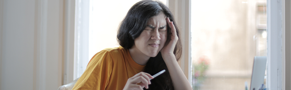 Woman suffering from headache/earache