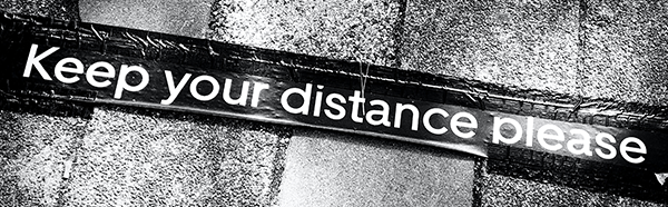 Keep you distance please taped on stone flooring