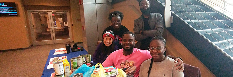 A group of NEOMED students around a table.