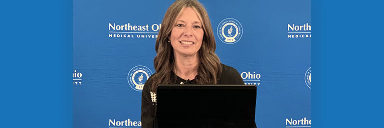 Dr. Amy Acton speaks at a podium.