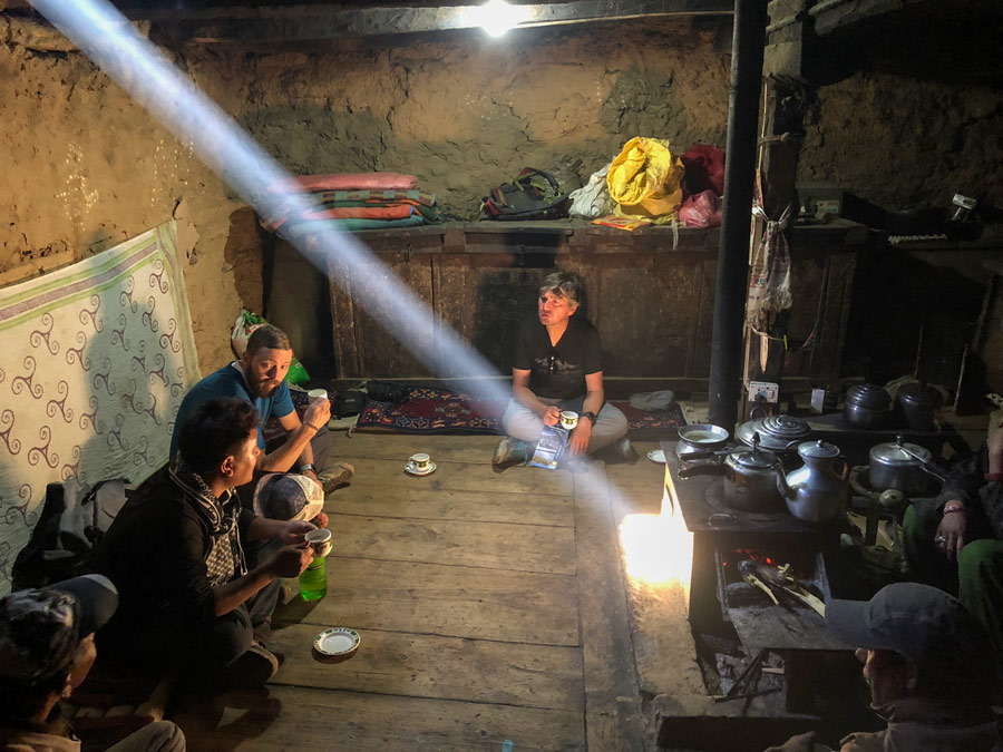 Physcians talk in a dark room with a shaft of sunlight streaming from the ceiling.