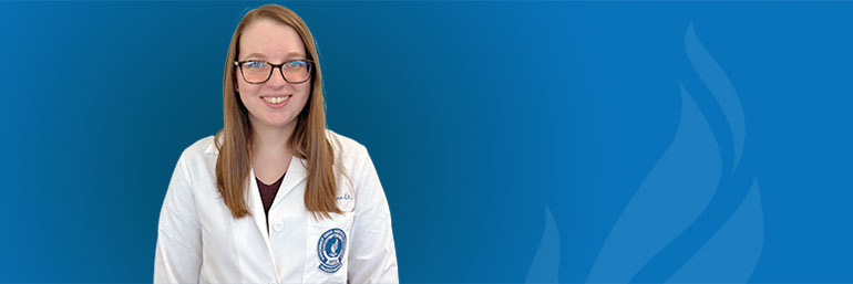 College of Graduate Studies student Gabrielle Frame in a white coat.